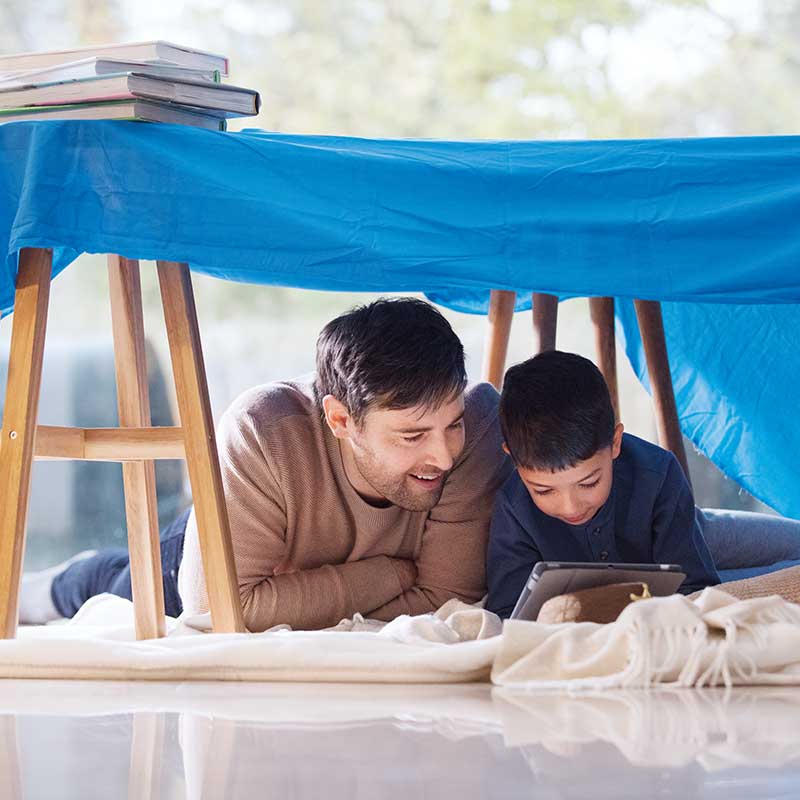 father and son looking at tablet