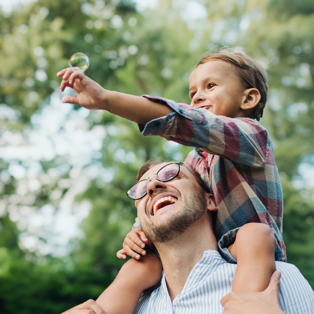 Happy young family playing with bubble wands