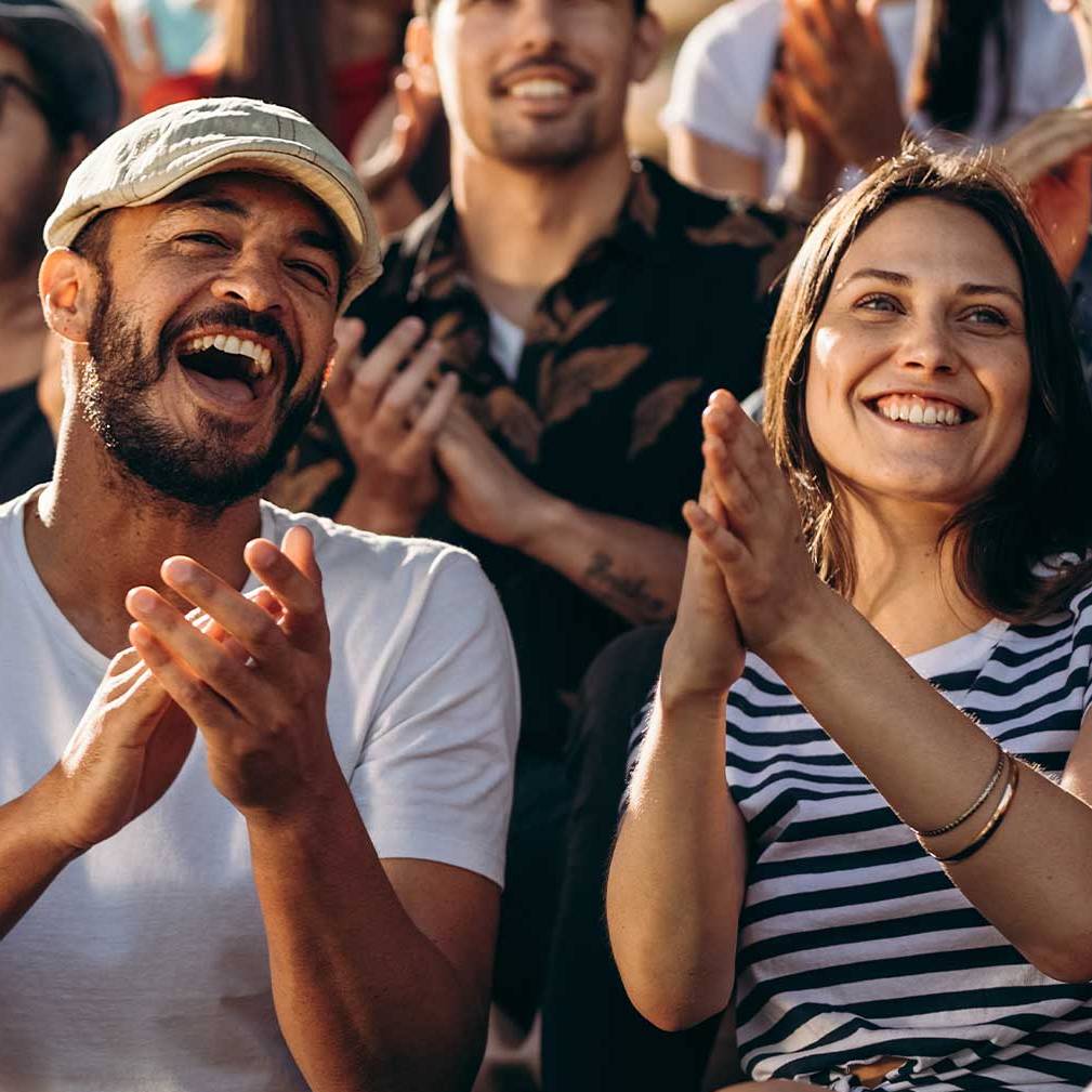 people clapping and laughing