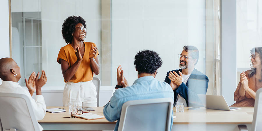 Successful business meeting with a creative team applauding their colleagues' project