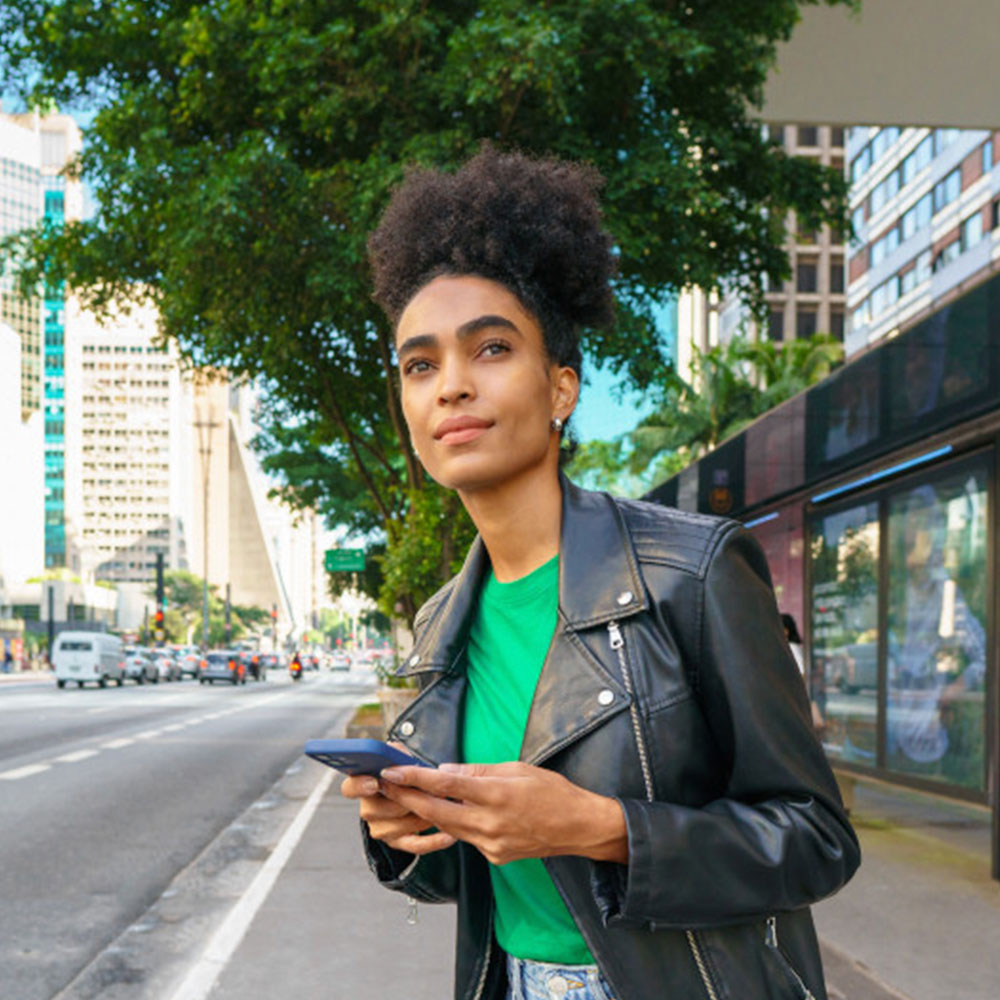 Woman on the street with her phone in her hand