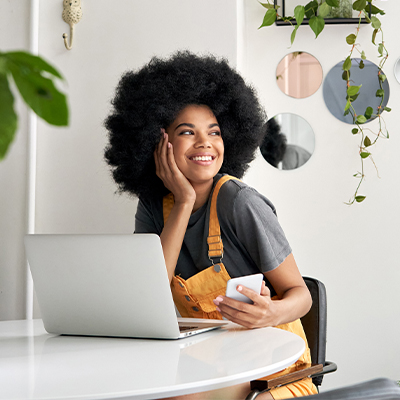 Woman working on a laptop and phone