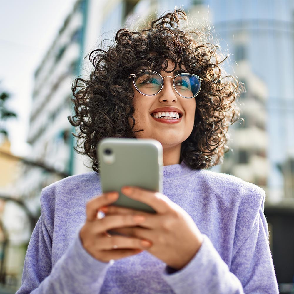 Woman smiling with a phone in her hand
