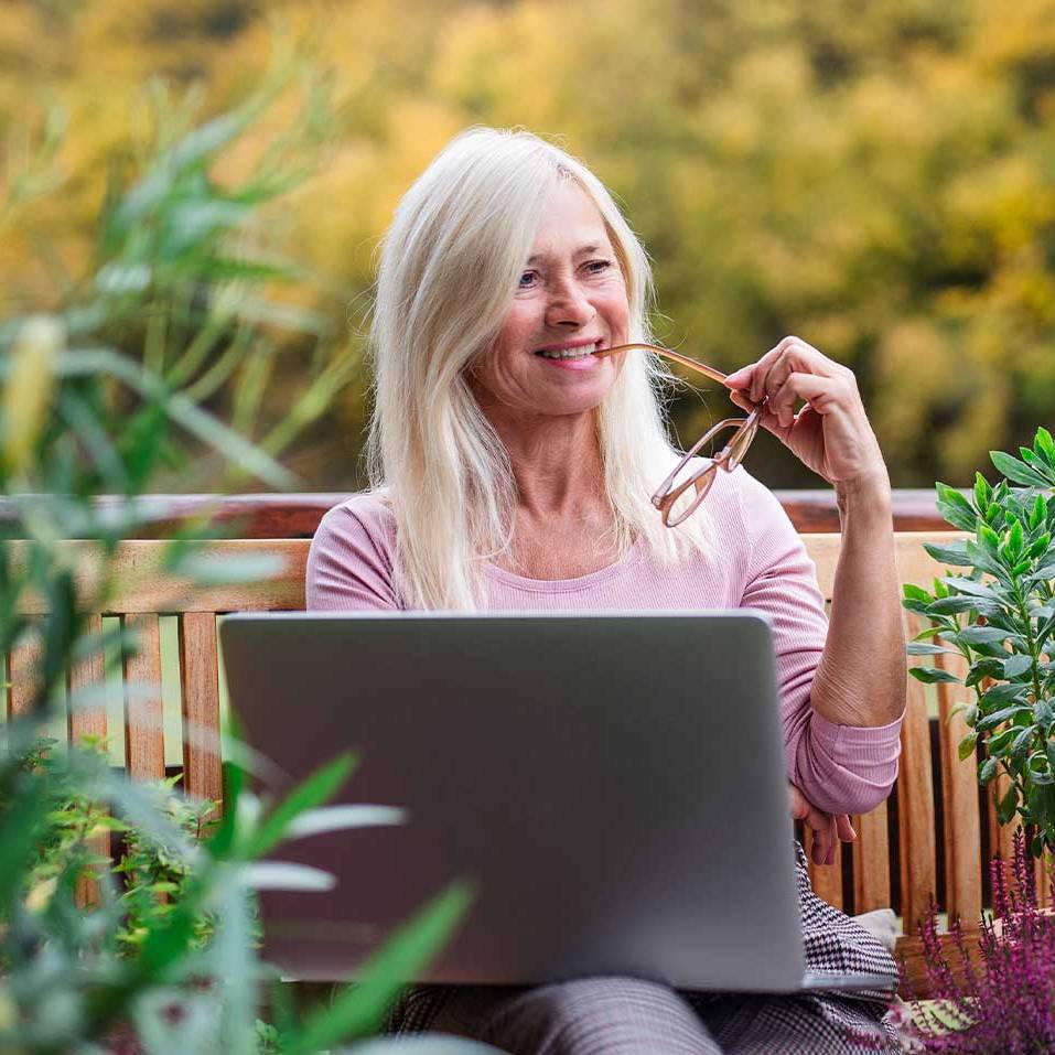 woman working on her computer on a terrace