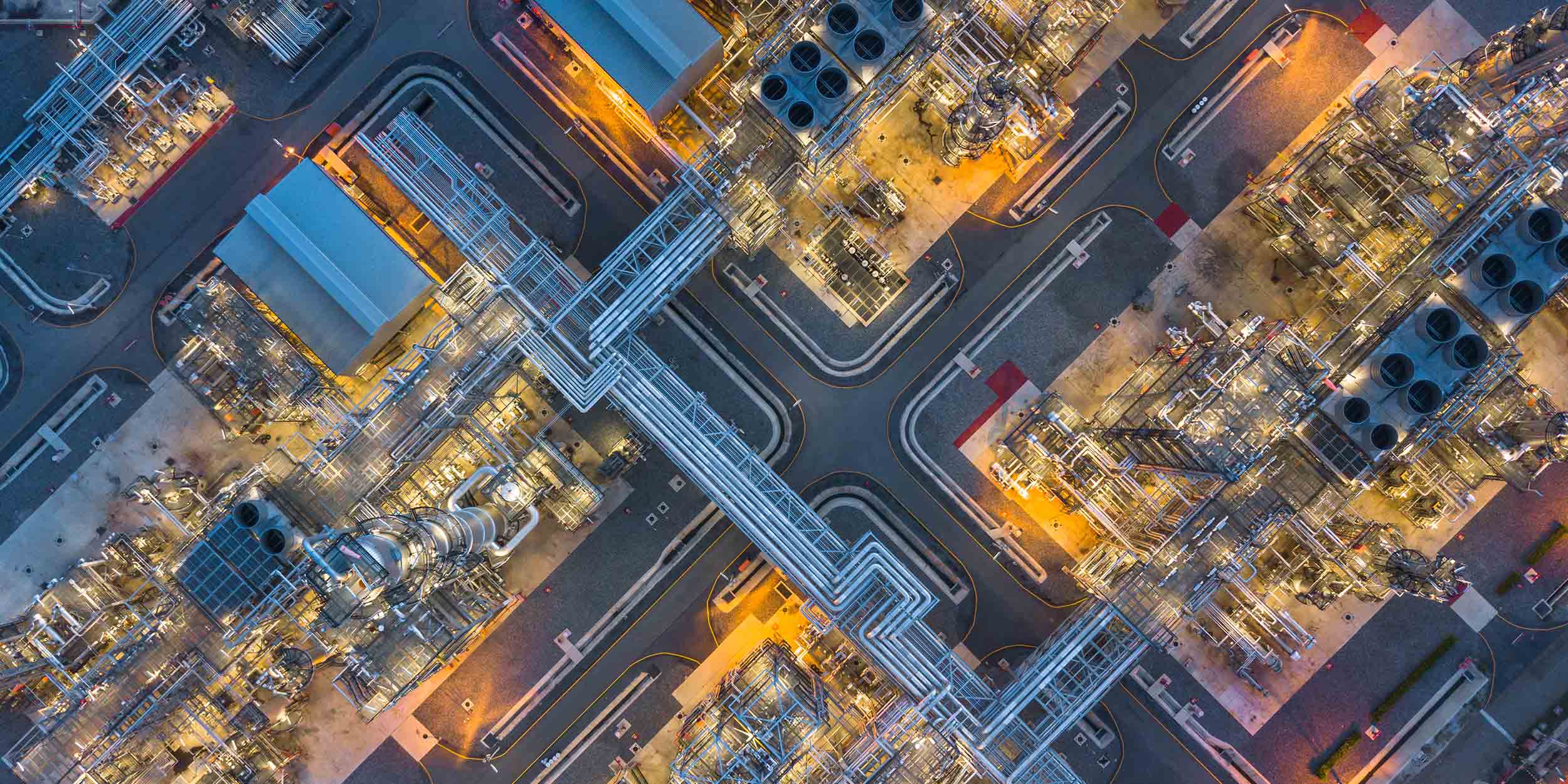 Aerial top view oil and gas refinery plant form industry zone at night