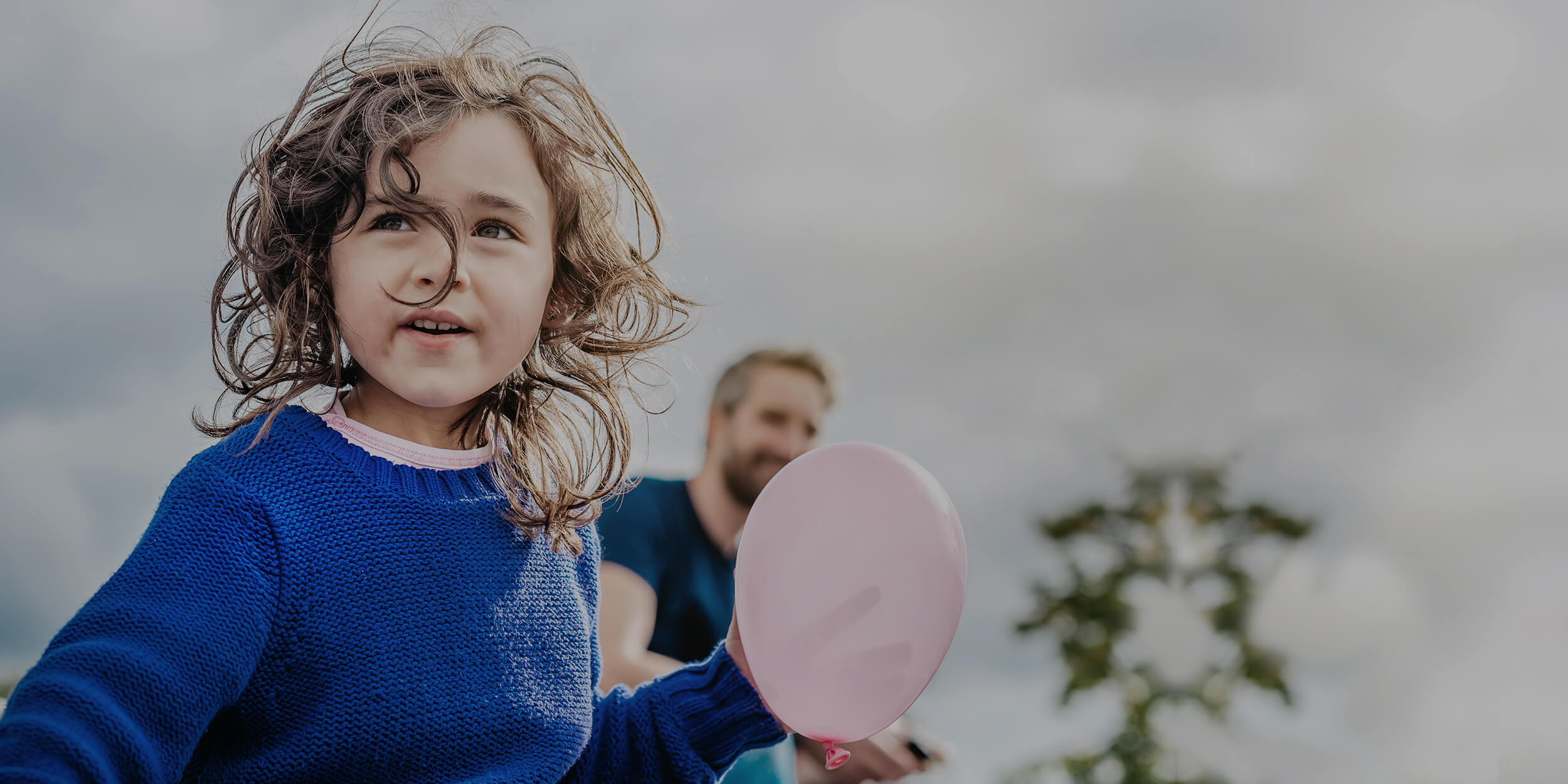 Girl and father playing outside