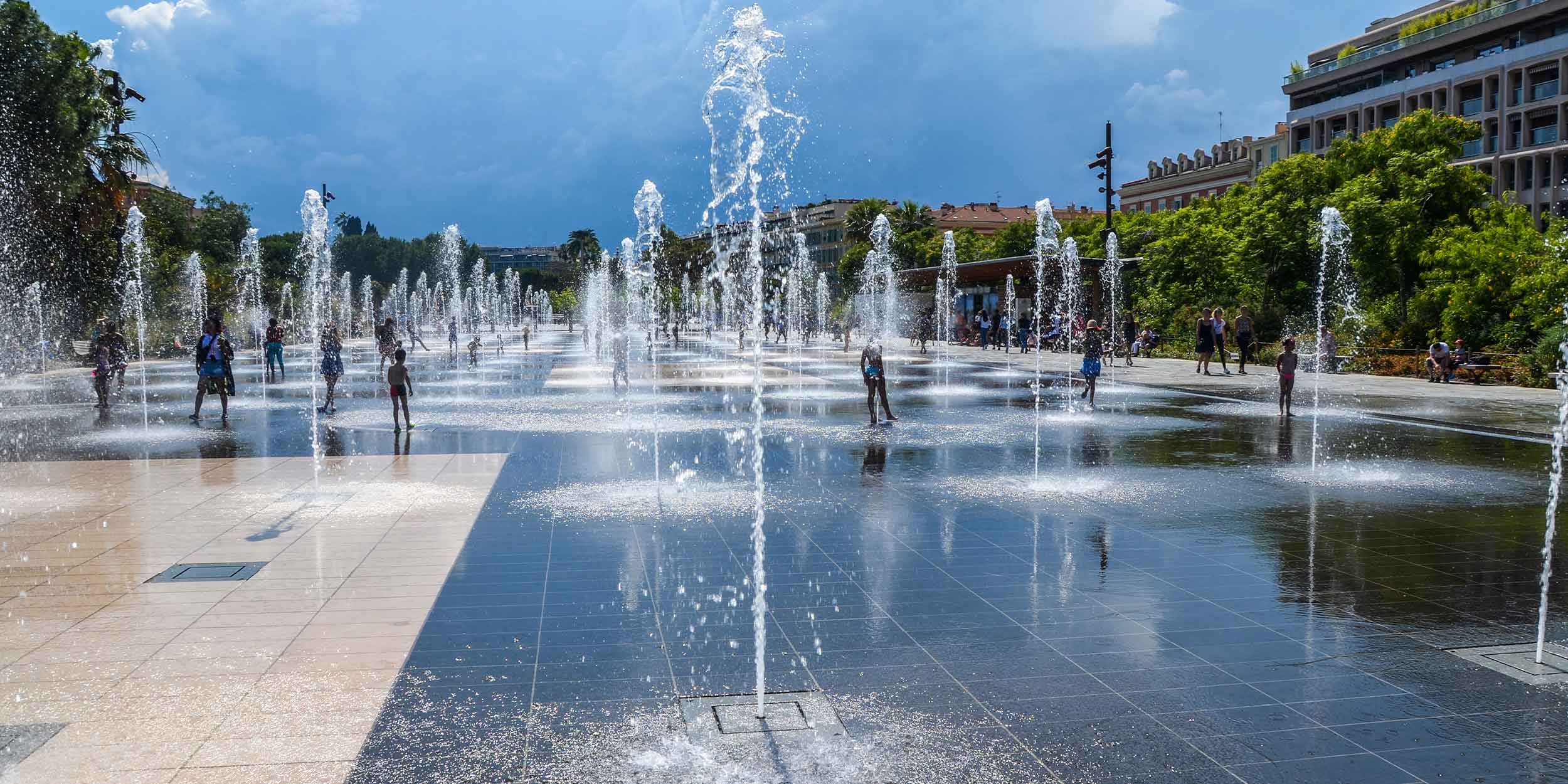 Kids playing in the water of fountains