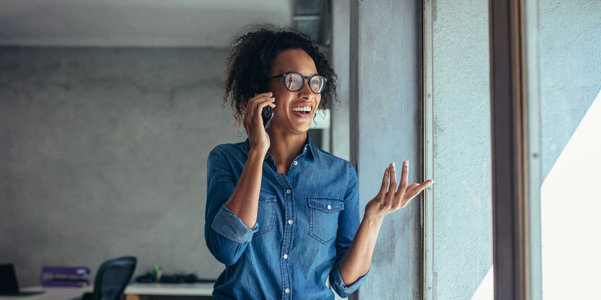 Cheerful young woman talking on mobile