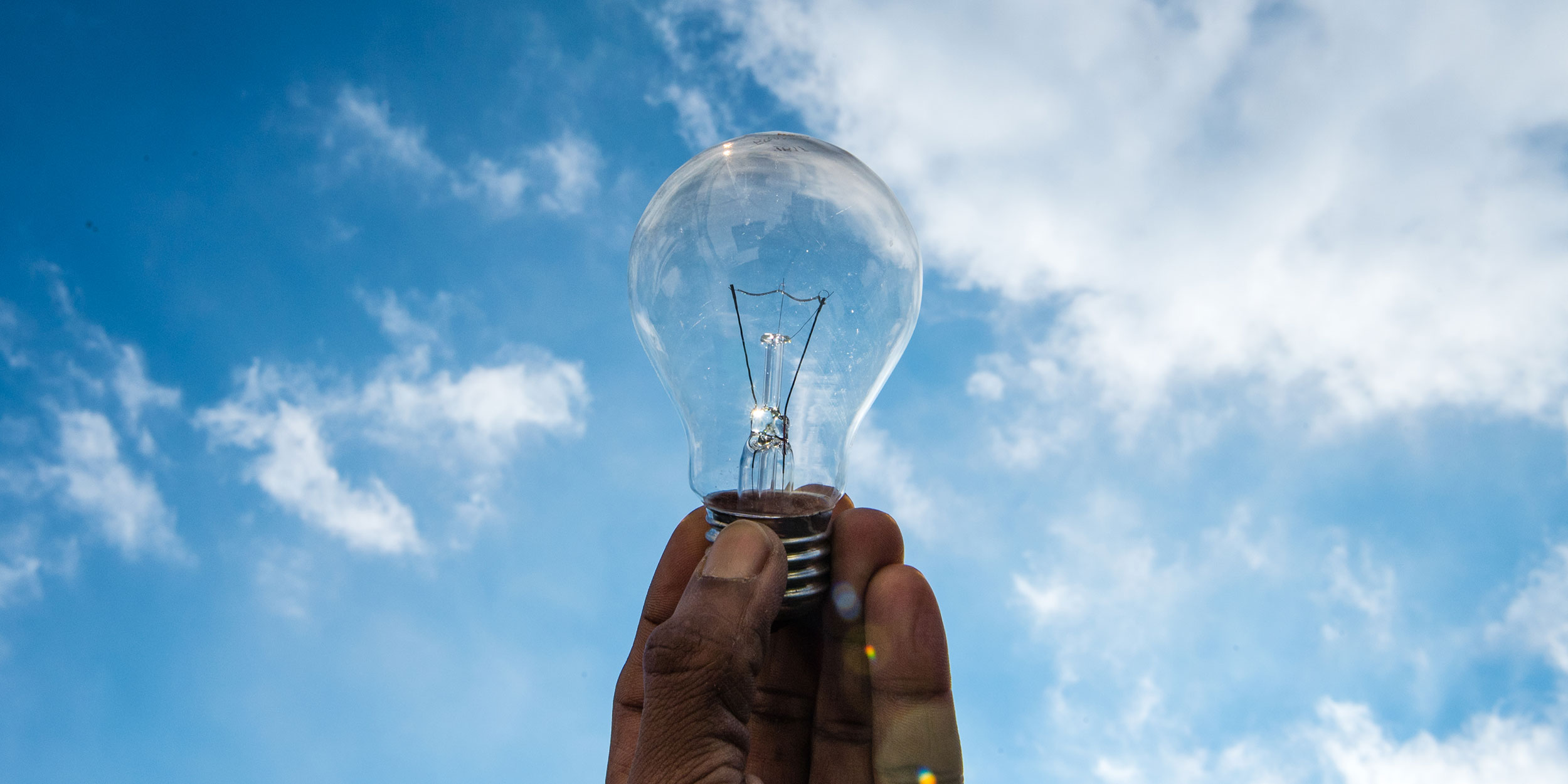 holding a lightbulb