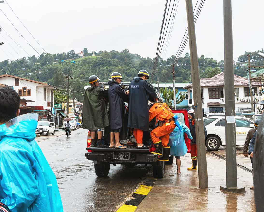 people walking in flooded street