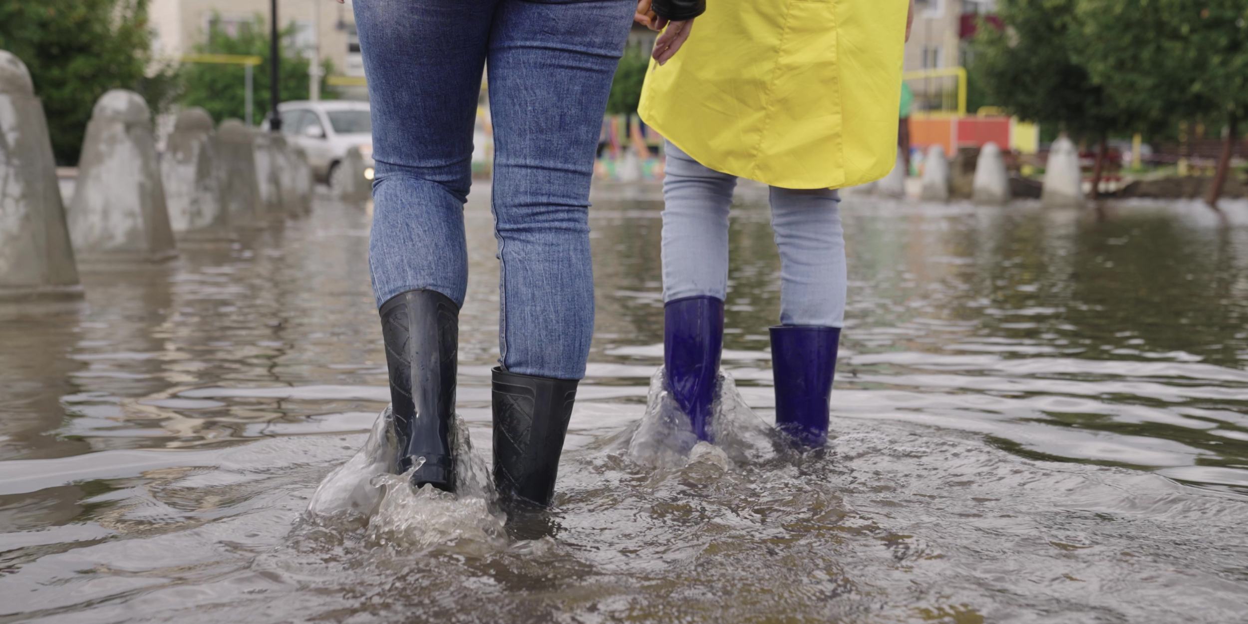 people walking through flooded street
