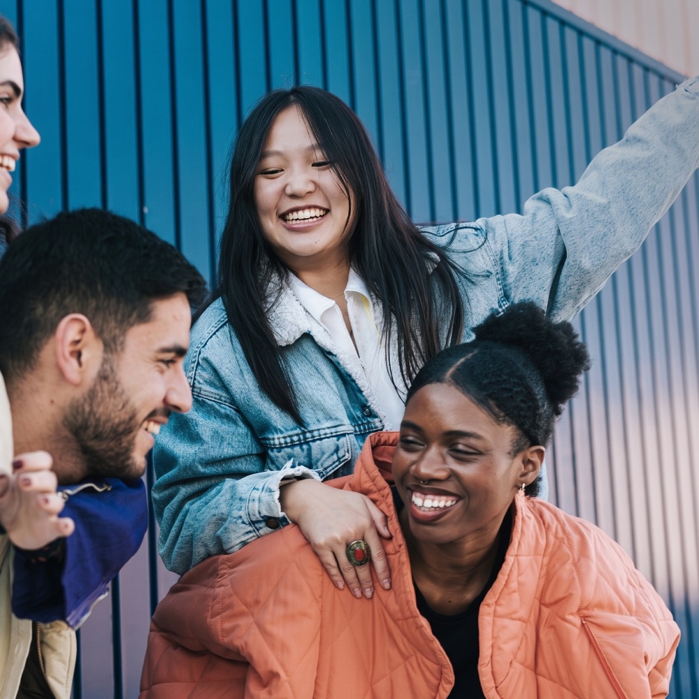 four people gathered together outdoors