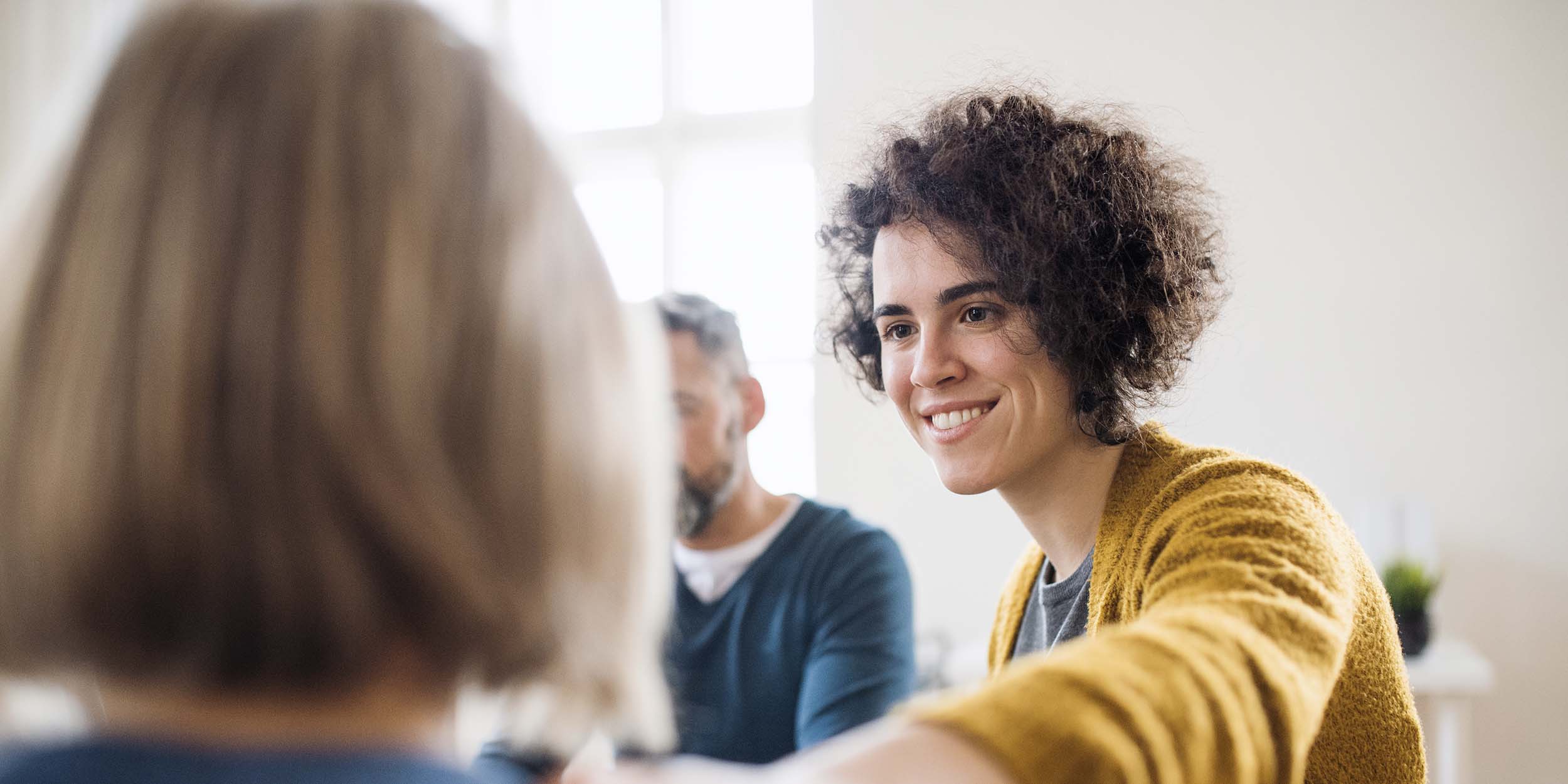 woman is putting her hand supportive on other woman's shoulder