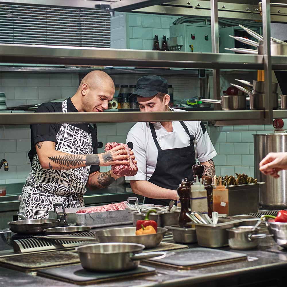 Restaurant kitchen team preparing food in a professional kitchen