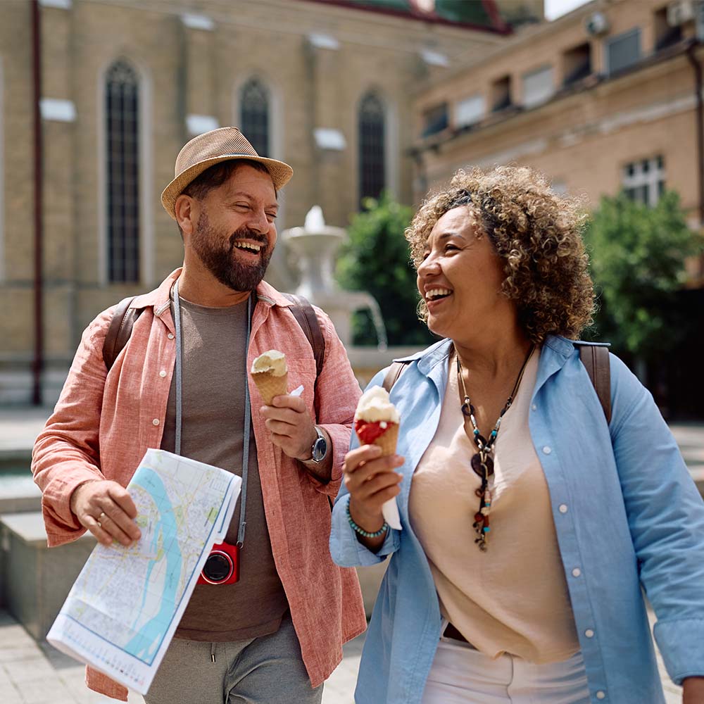 Two travelers exploring a city while enjoying ice cream and sightseeing