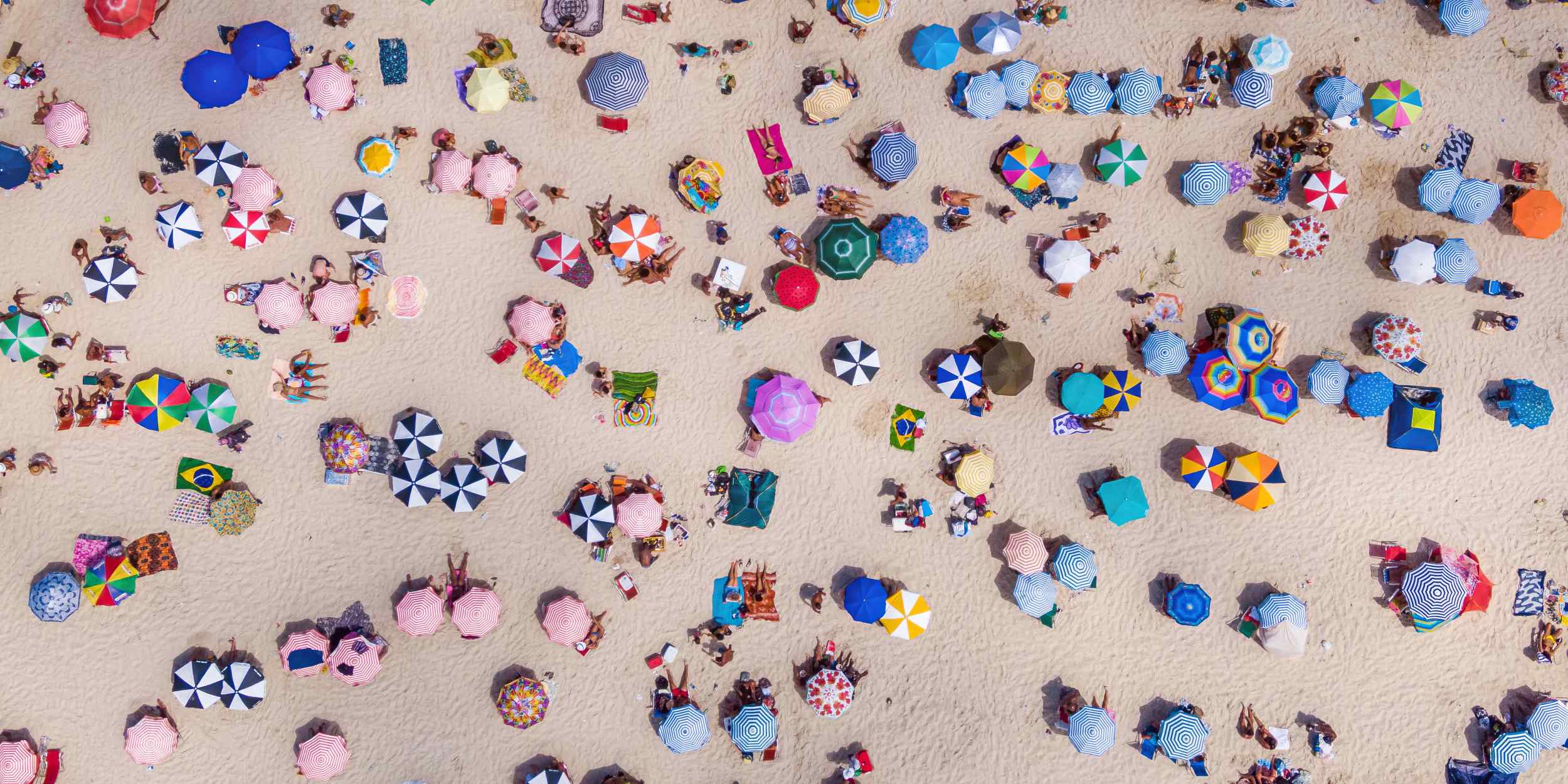 aerial view of crowded beach umbrellas