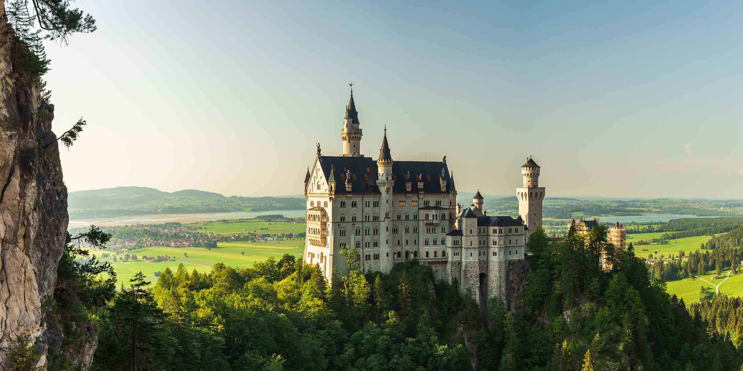 Historic castle overlooking a forested landscape and countryside