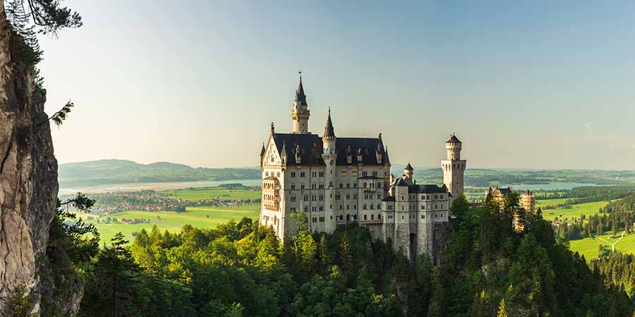 Historic castle overlooking a forested landscape and countryside
