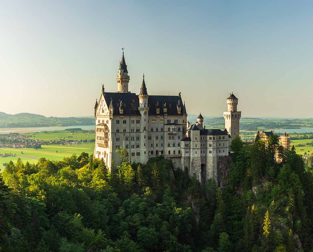 Historic castle overlooking a forested landscape and countryside