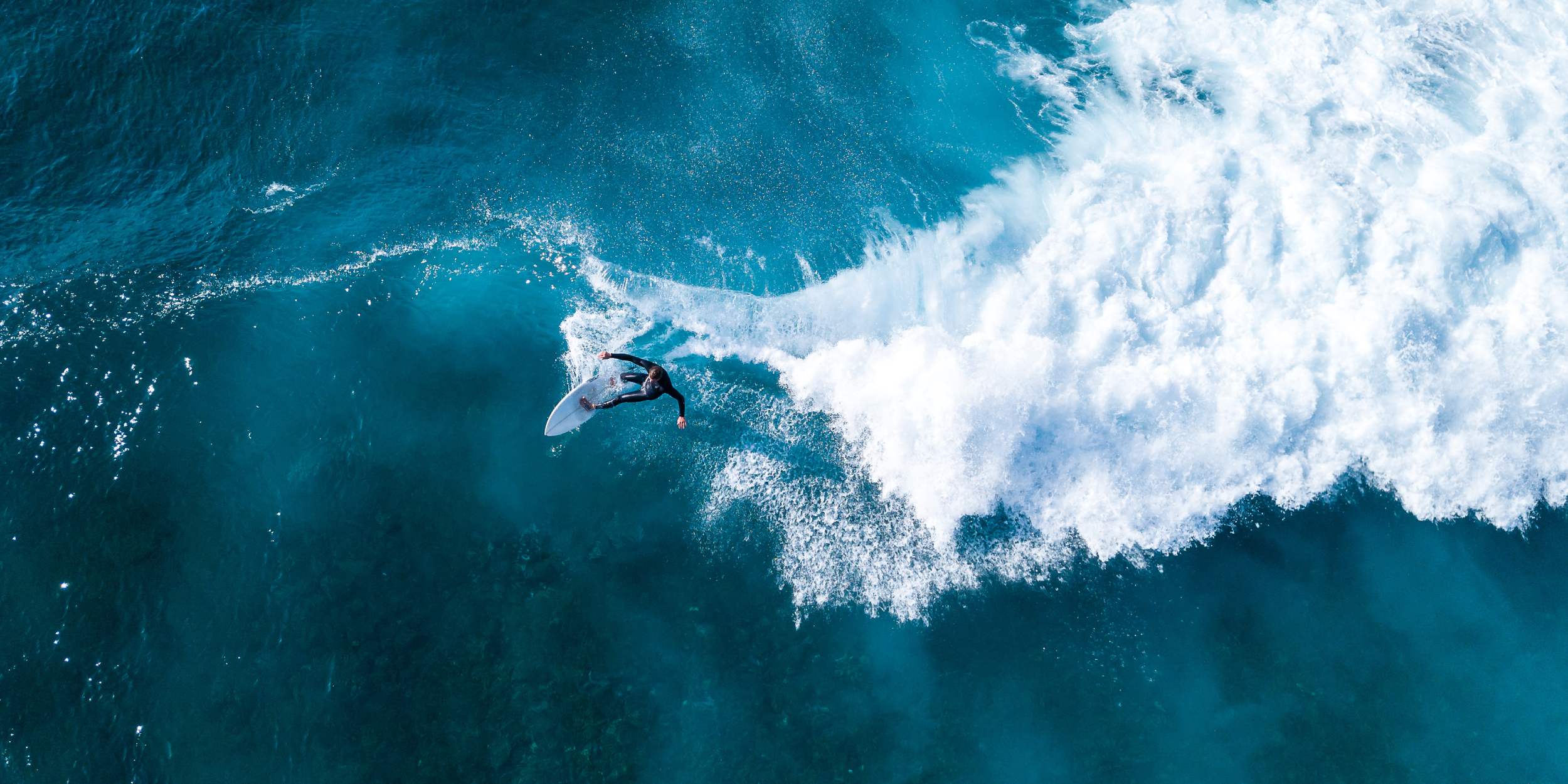 surfer riding breaking ocean wave
