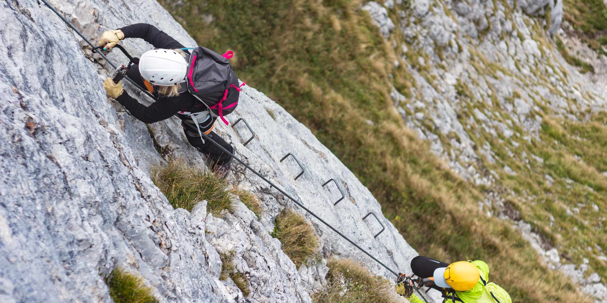 climber ascending rocky mountain