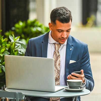 man looking at phone while working