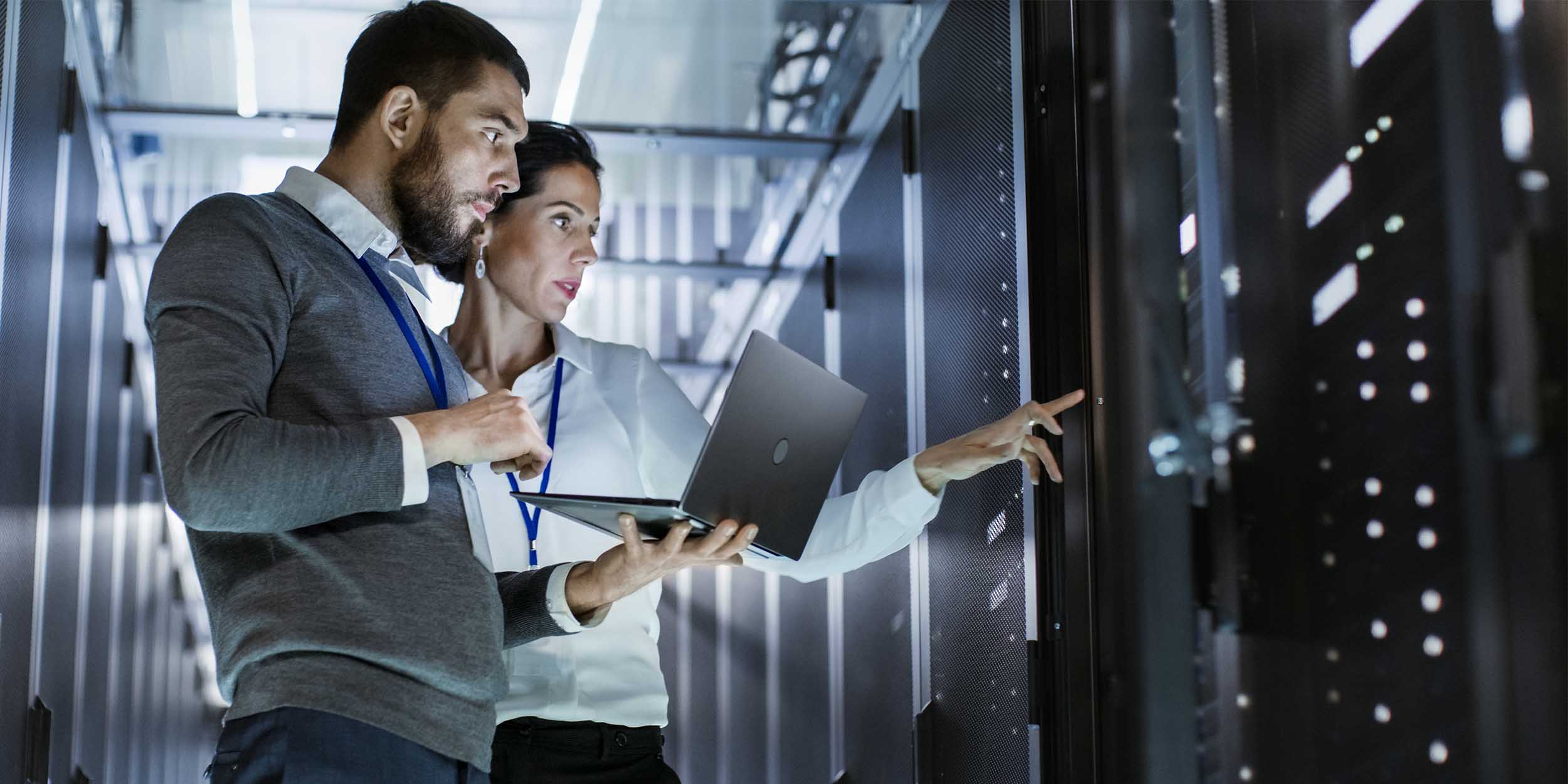 Technology professionals inspecting servers in a data center