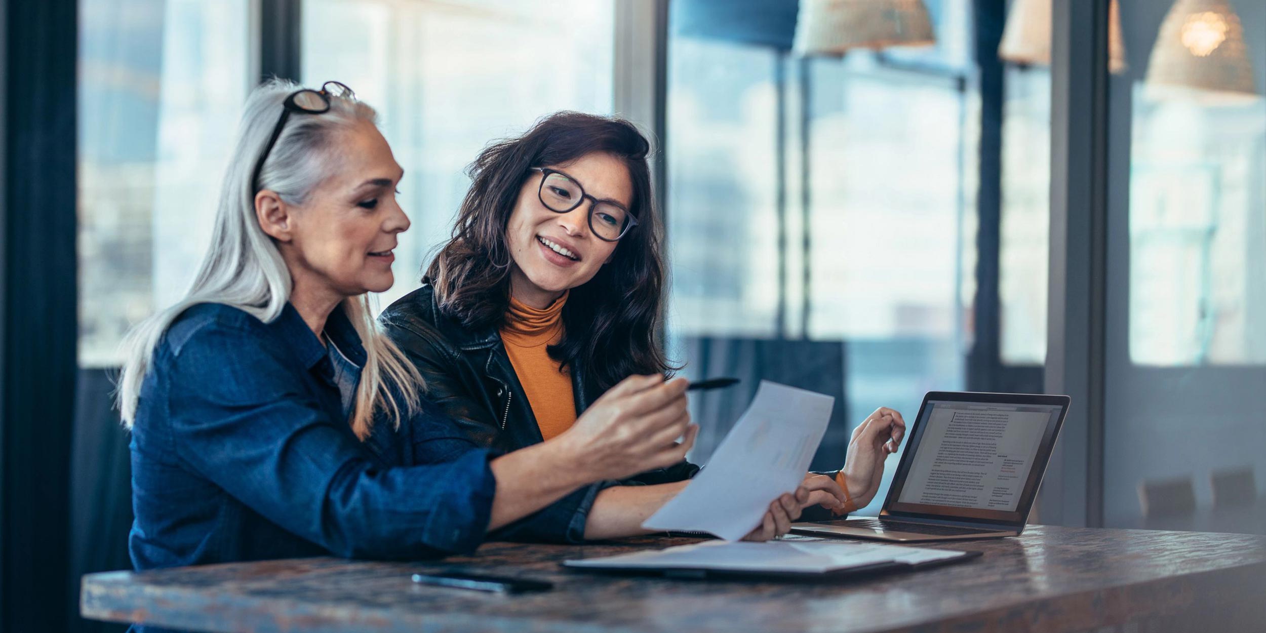 women talking about a paper