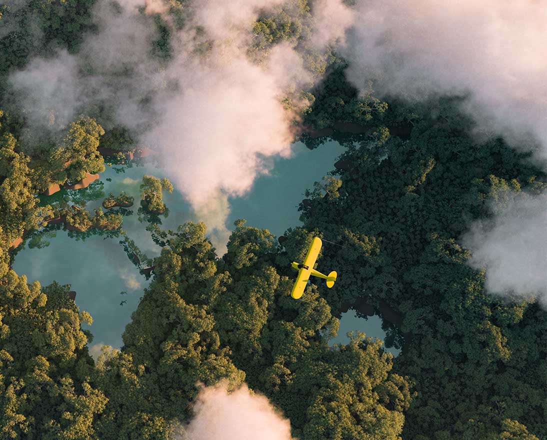 yellow plane flying over lakes and forest