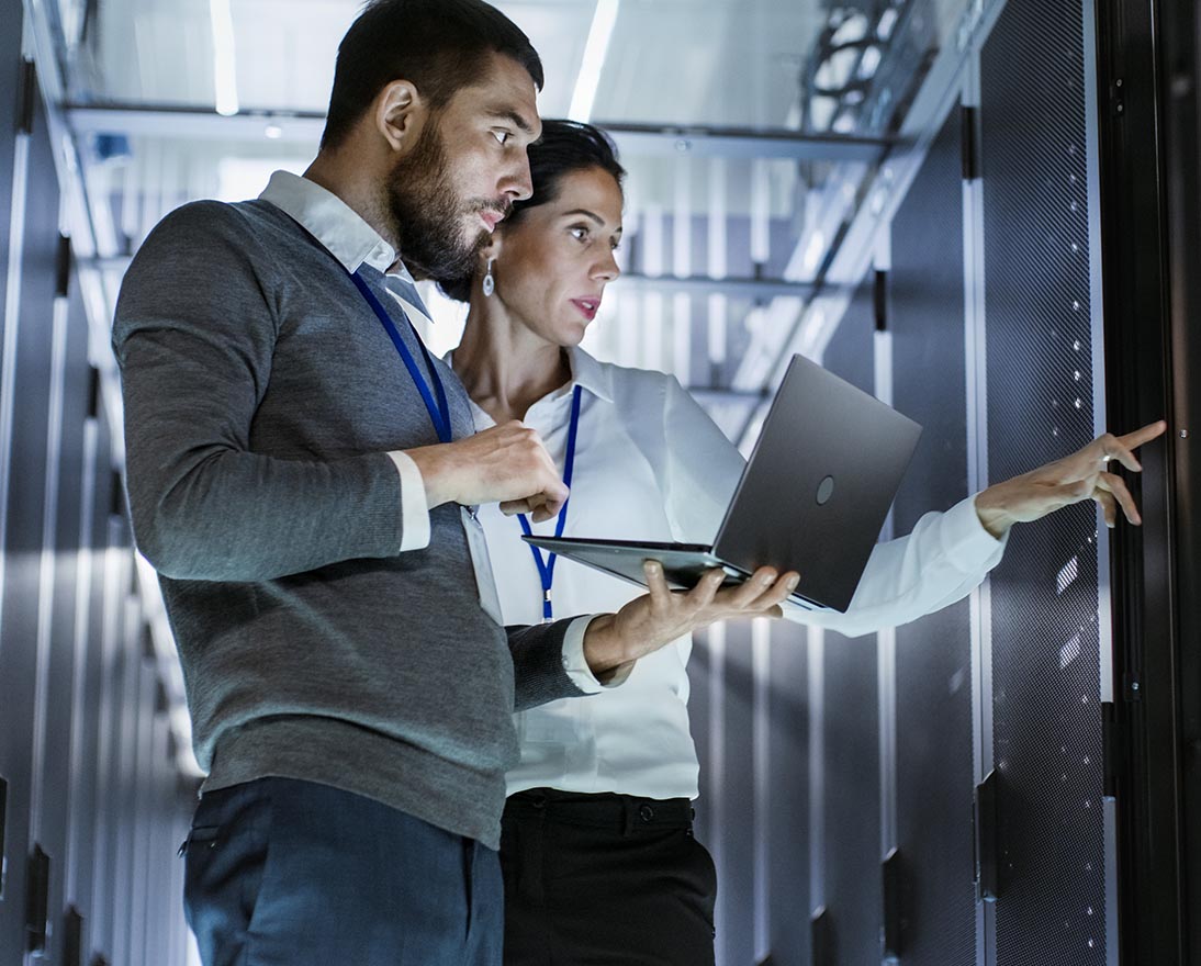 Technology professionals inspecting servers in a data center