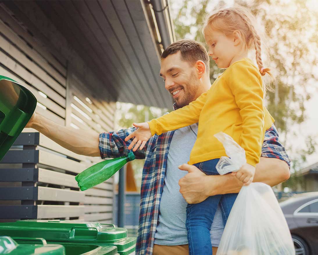 father and daughter recycling