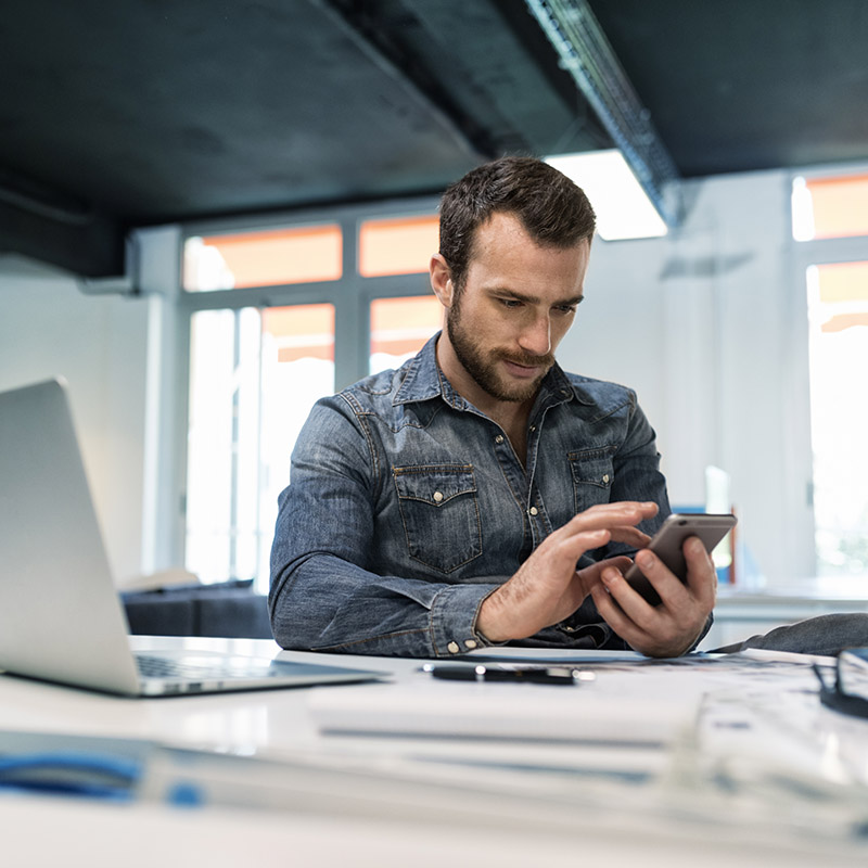 Man in modern office working on laptop