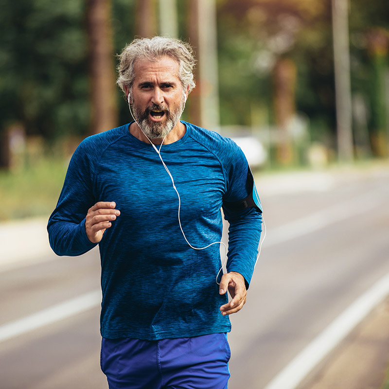 Active man jogging on a sunny day