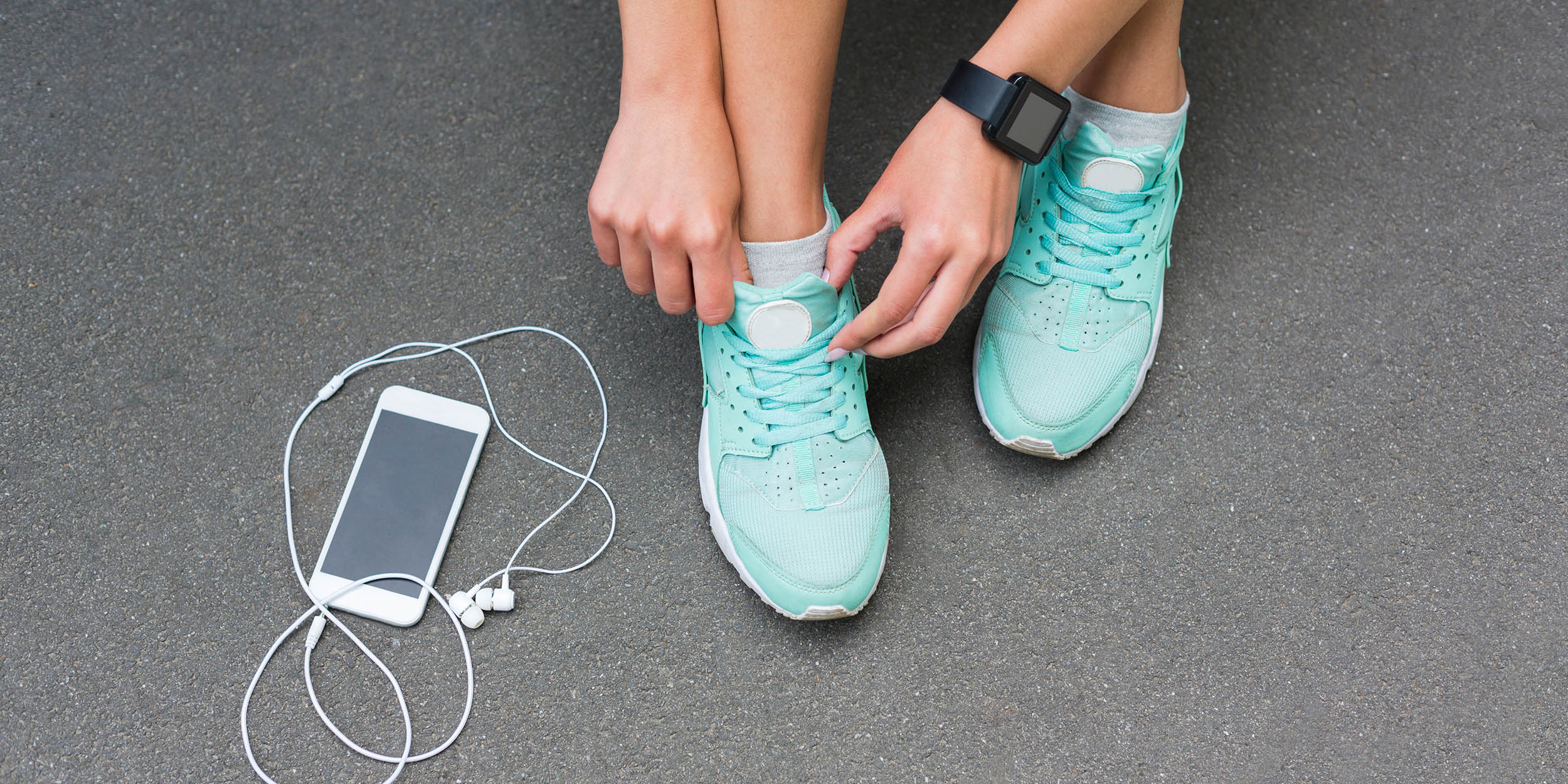 Woman tying shoe laces before running