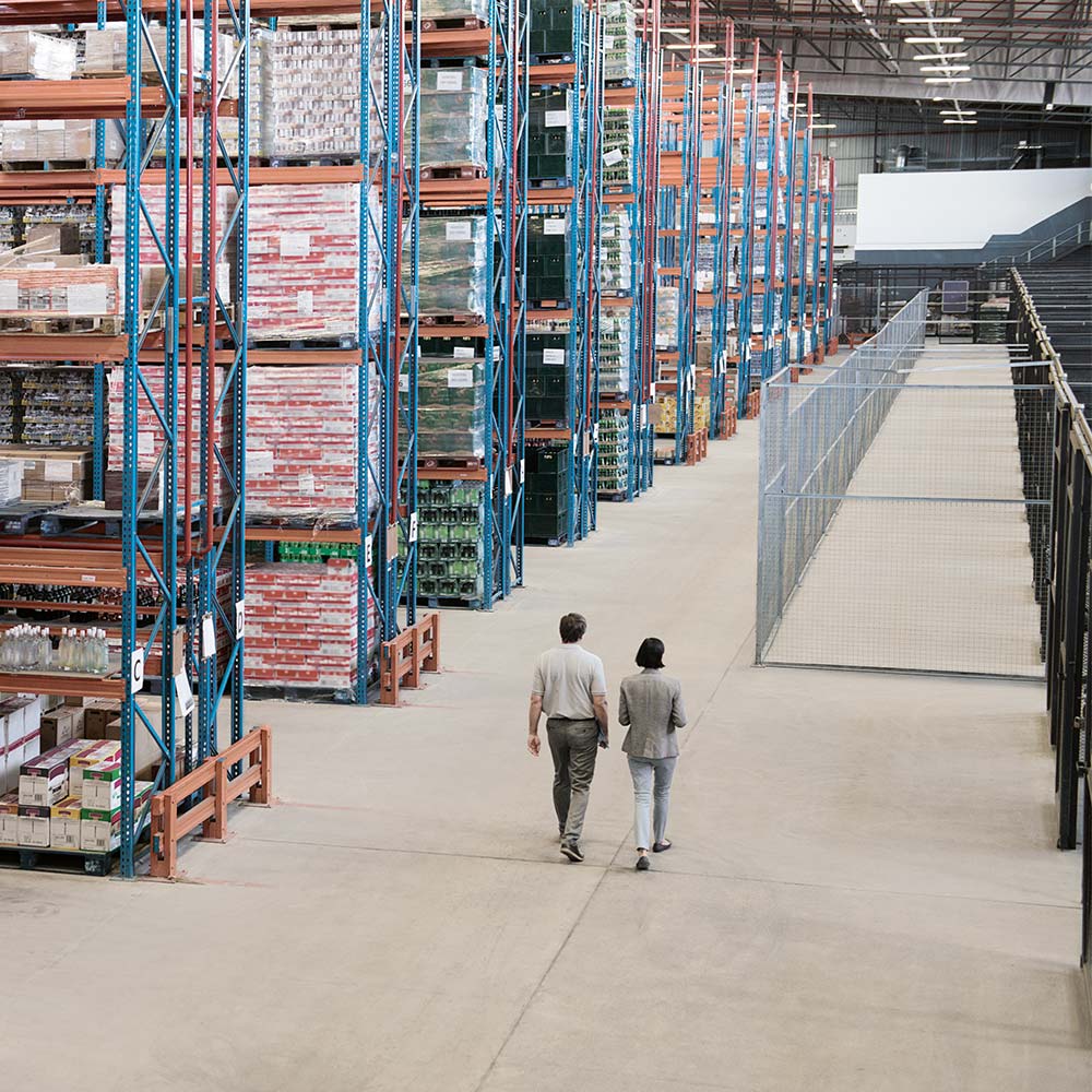 woman and man walking through storage