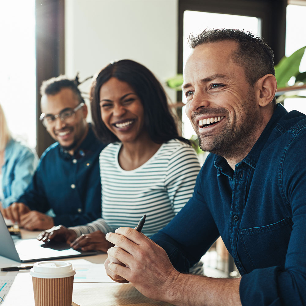 businesspeople laughing while sitting together