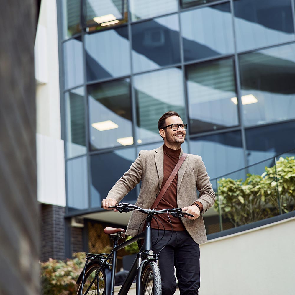 man walking with the bike