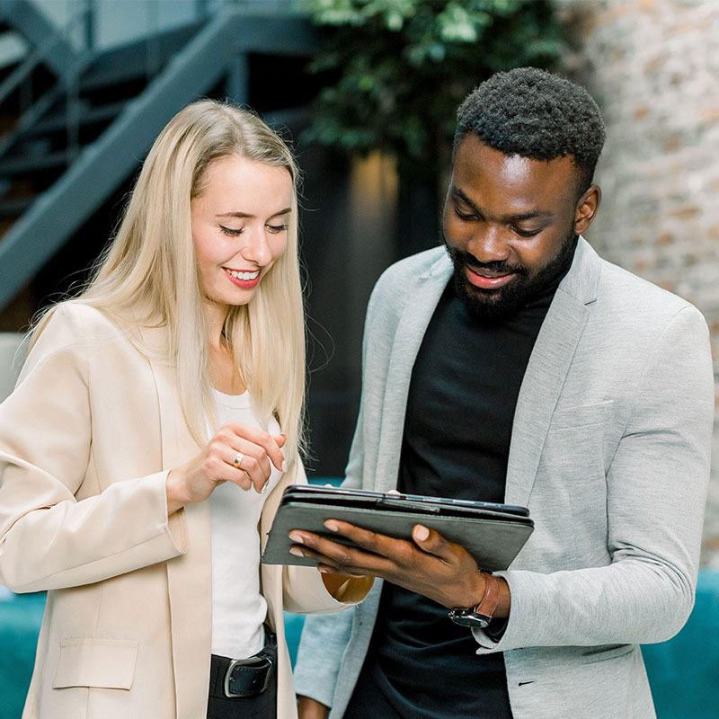 two colleagues looking at a tablet together