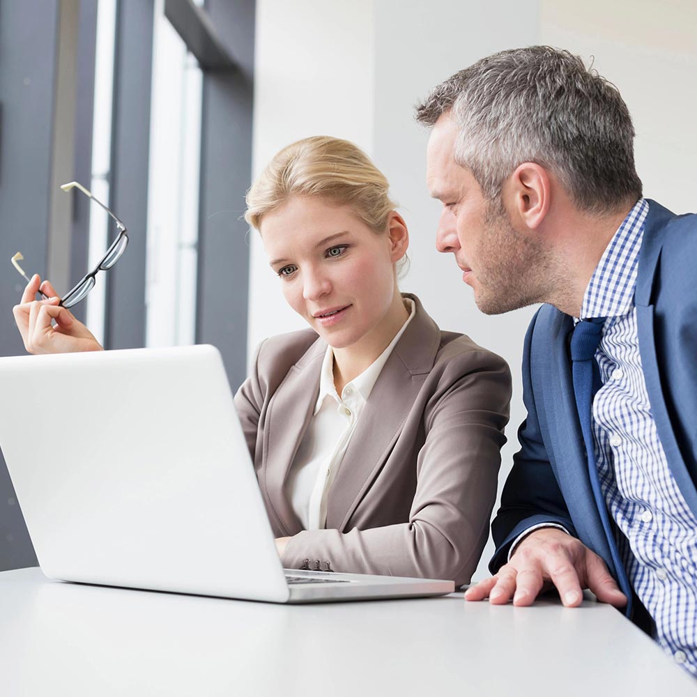 woman and man working on laptop