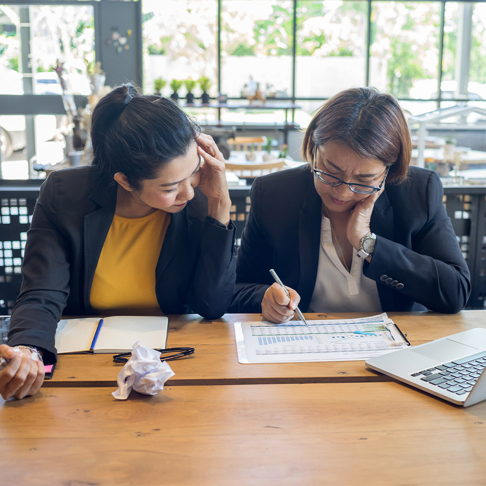 Two people looking at documents together