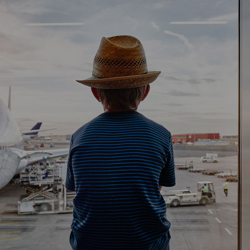 kid watching plane at the airport