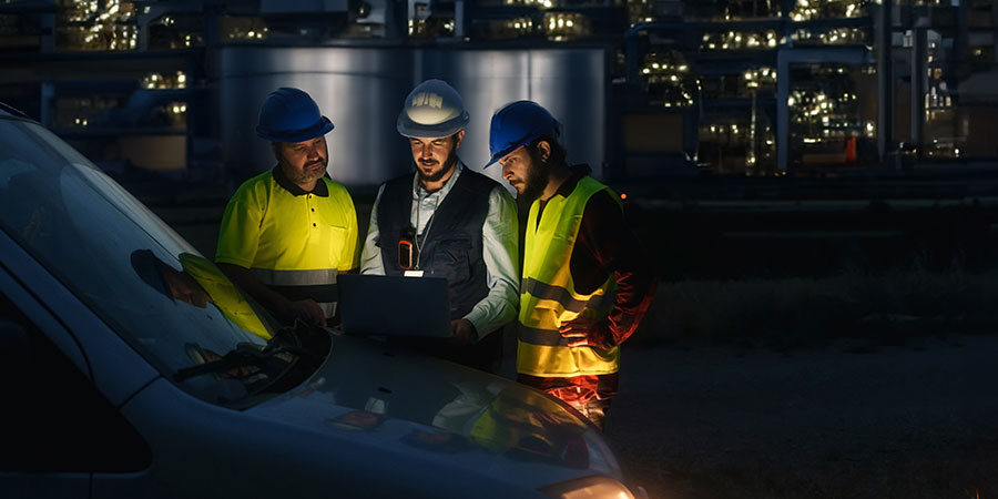 Happy male and female business people talking while standing in office