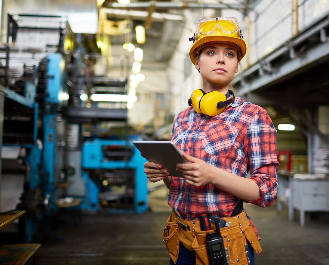 woman wearing protective equipment standing in factory