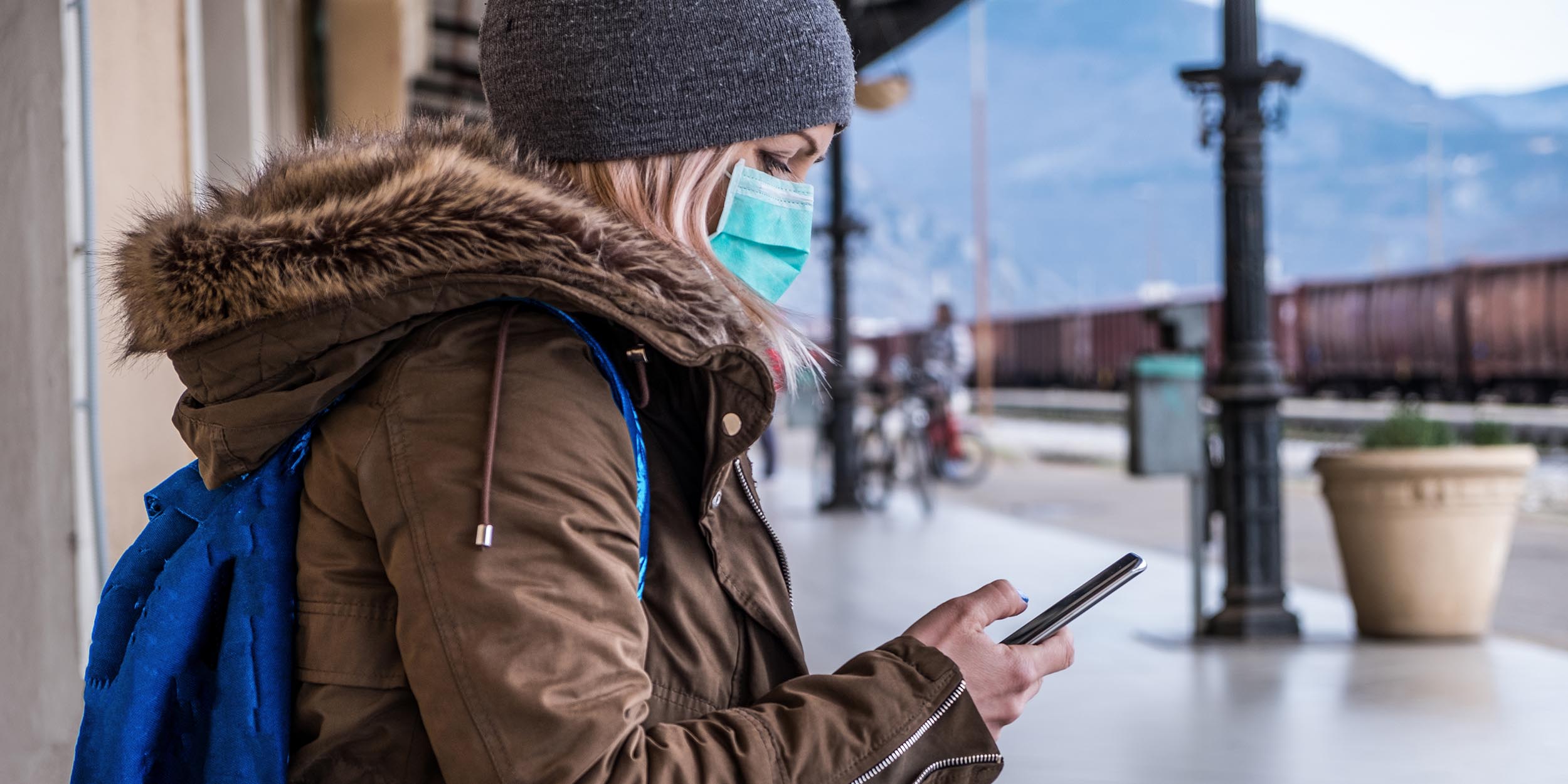 Woman wearing face mask at the station
