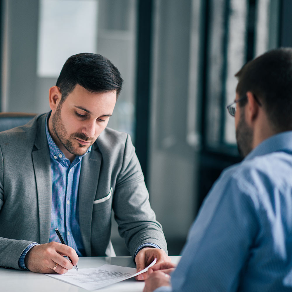 Two people looking at a document together