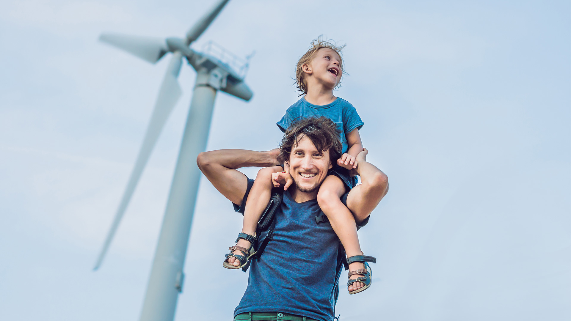 father and daughter in front of a windmill