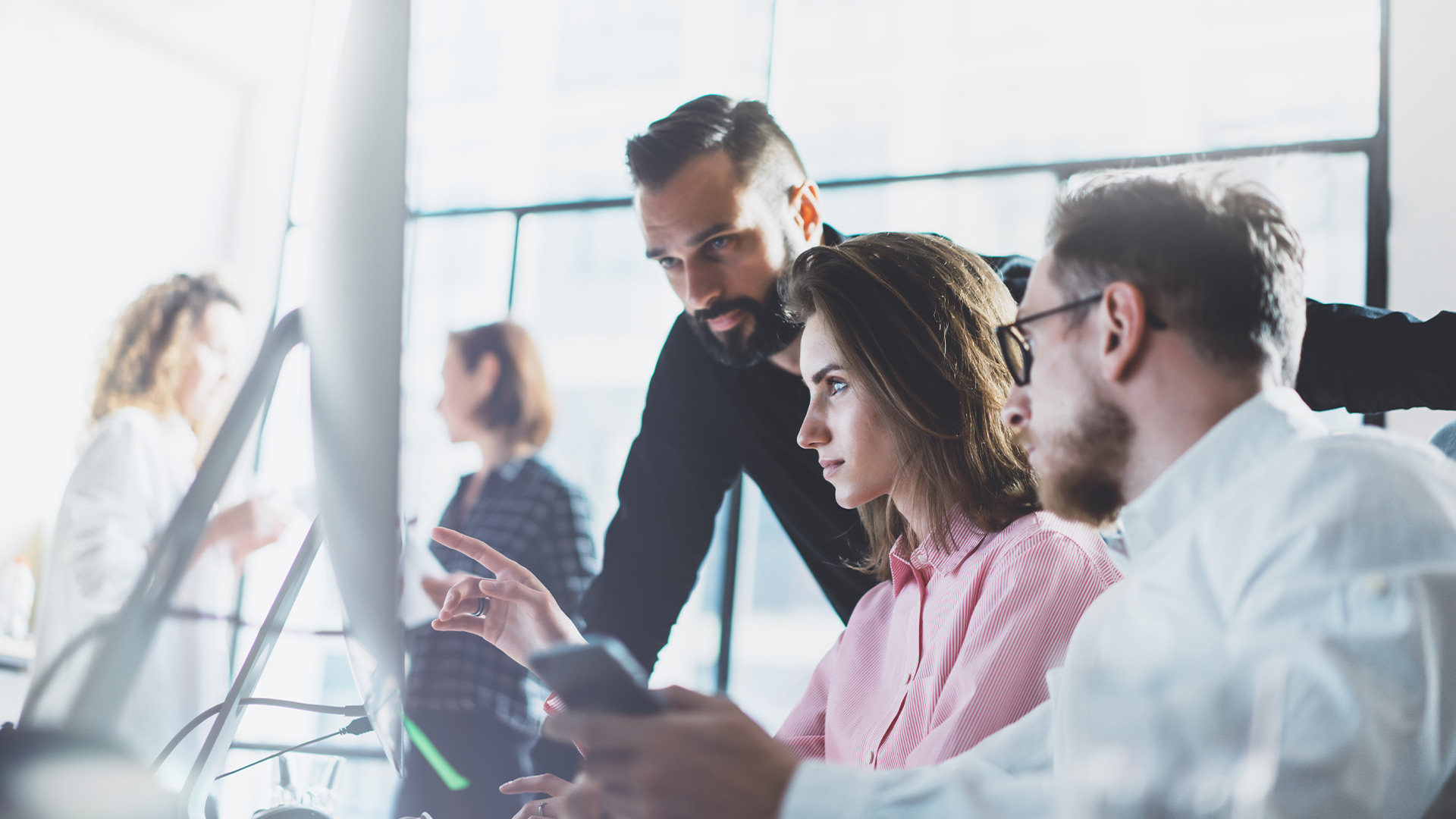 people working together in front of a computer