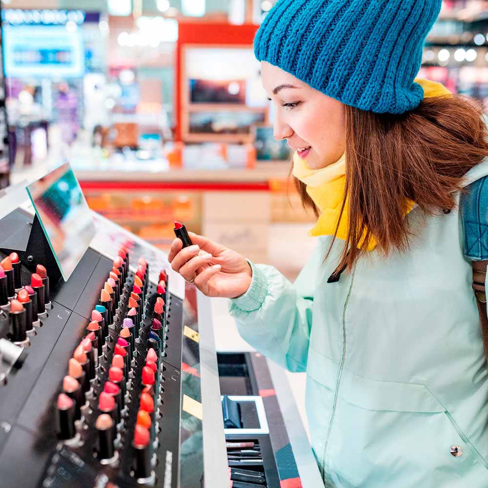 Woman shopping for lipstick and other cosmetics in a store