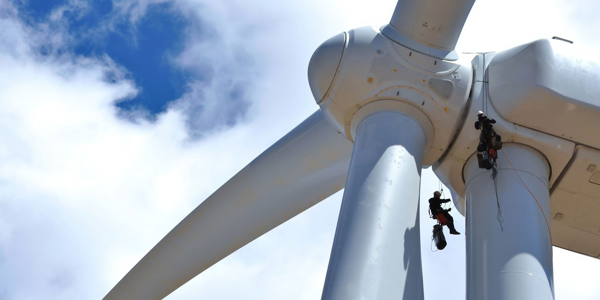 Workers on a wind turbine creating renewable energy