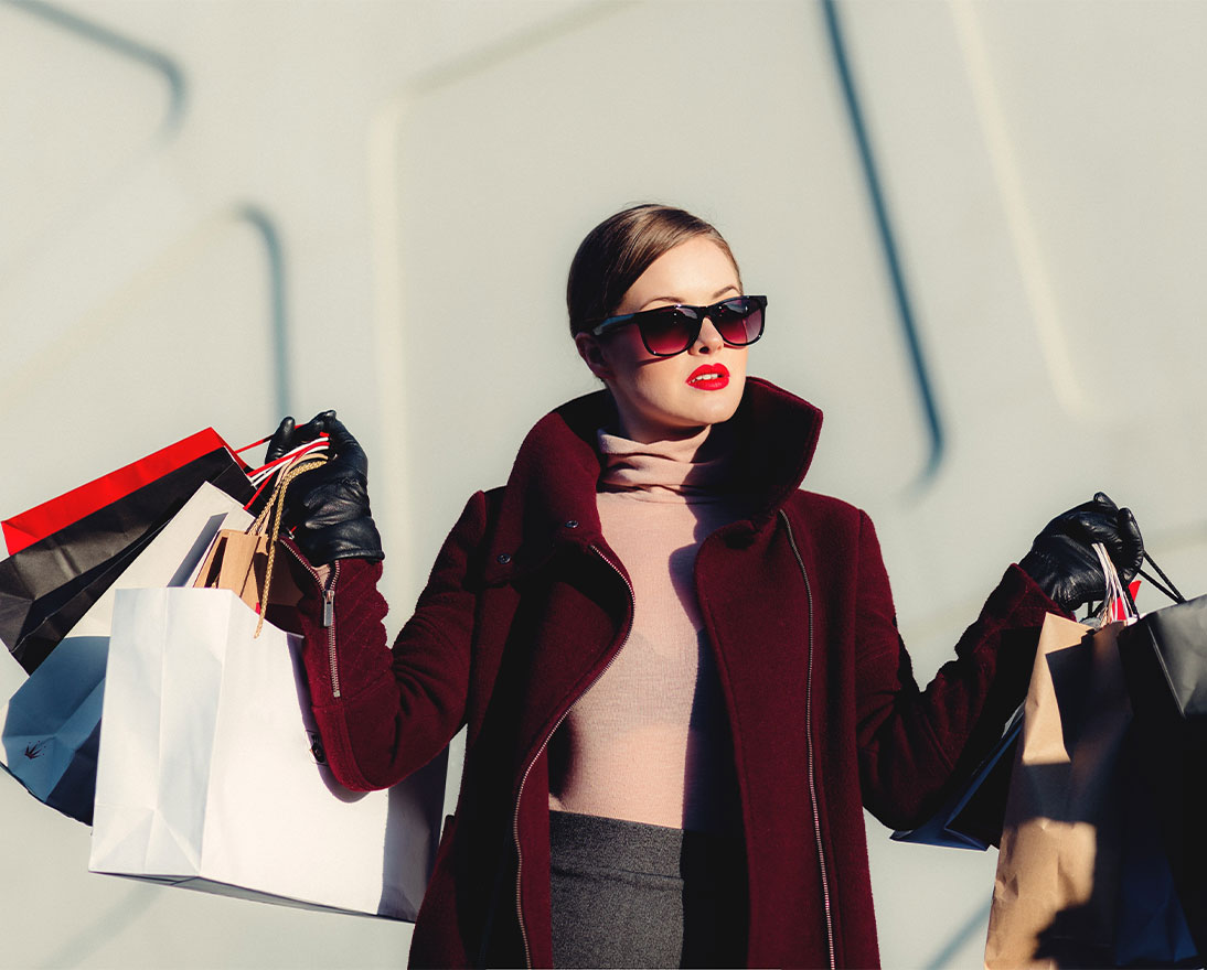 woman carrying multiple shopping bags